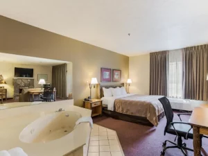 Quality Inn and Suites - bedroom and bathtub